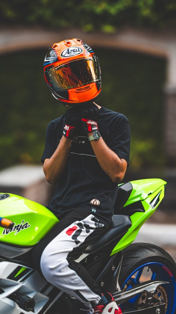 A person sitting on a motorcycle with a helmet on