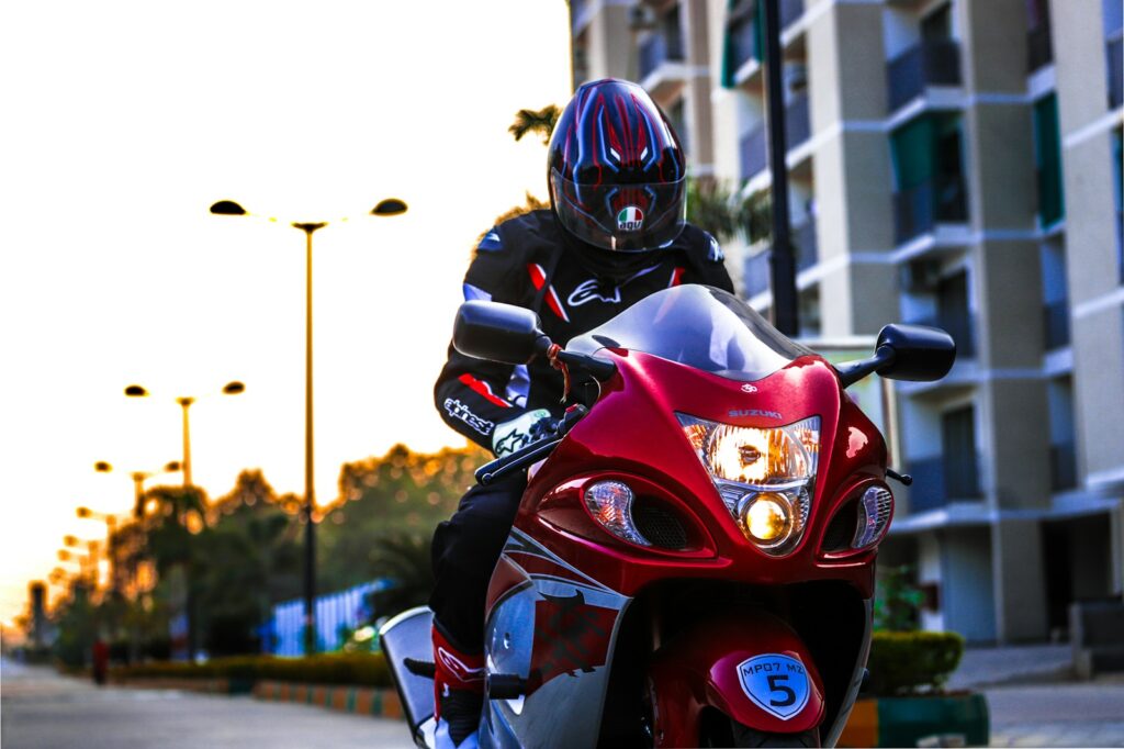 man in black helmet riding red sports bike