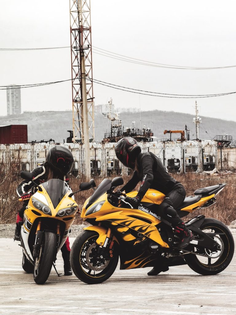 man in black helmet riding yellow sports bike during daytime